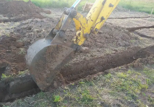 digging trench with excavator layer by layer